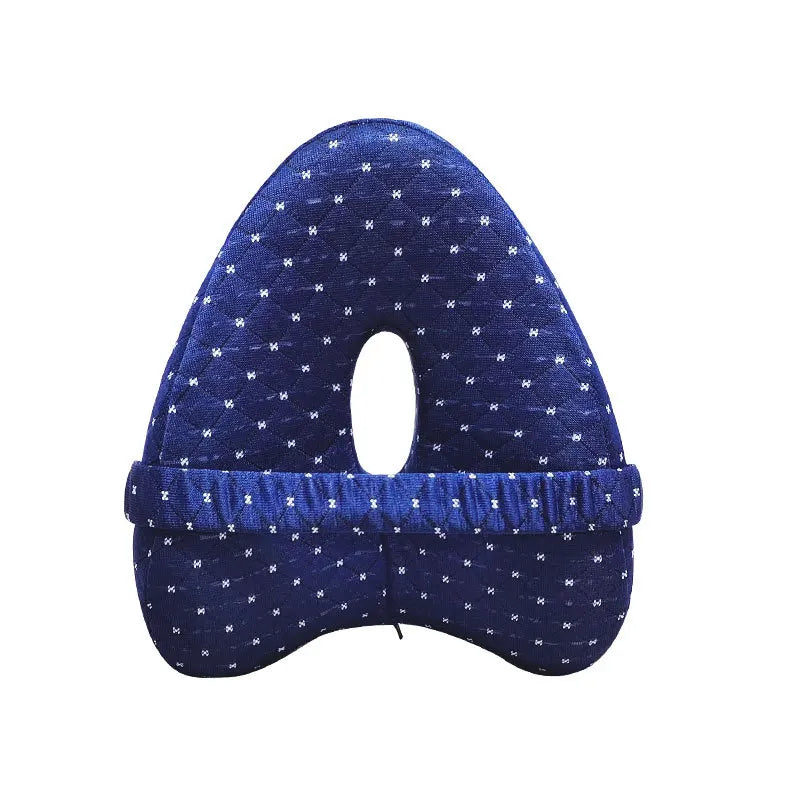 Dark blue maternity knee pillow with dotted pattern, center hole, and elastic strap for side sleeping support.